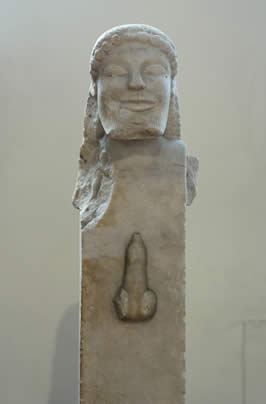 a sculture of Hermes's face on a rectangular base which includes an erect penis