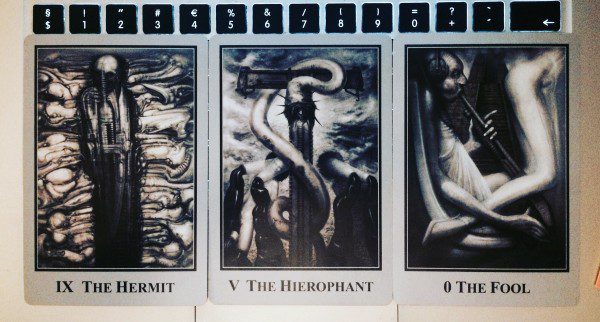 three tarot cards: the hermit, the hierophant, and the fool