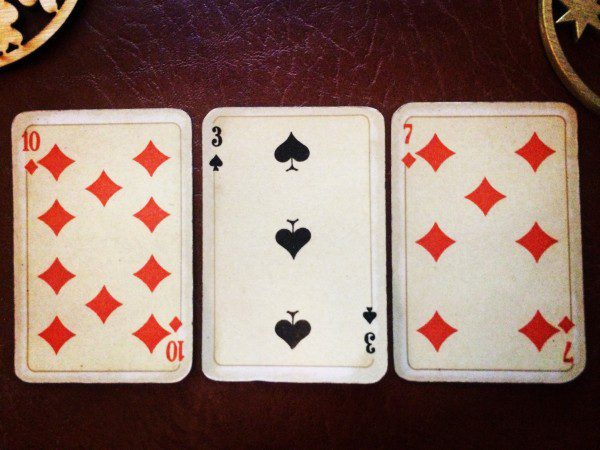 three playing cars on a table