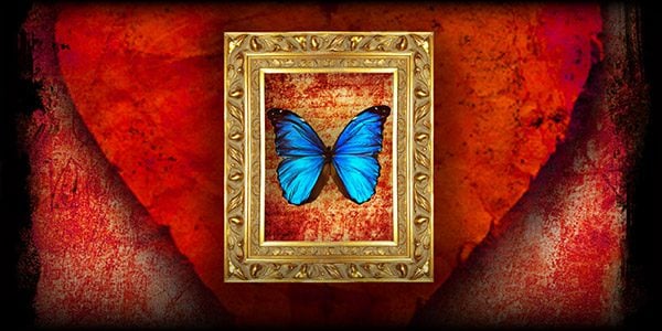 a blue butterfly framed in gold on a field of red