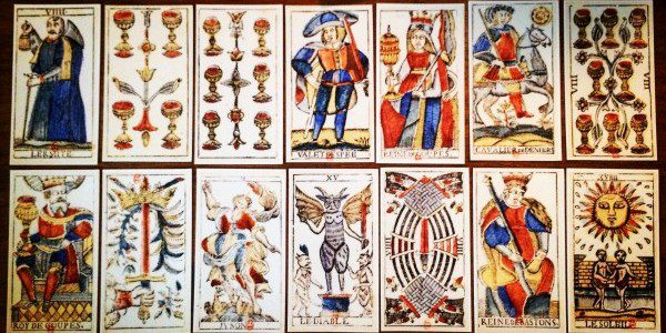 a tarot spread displaying fourteen different cards in two rows of seven