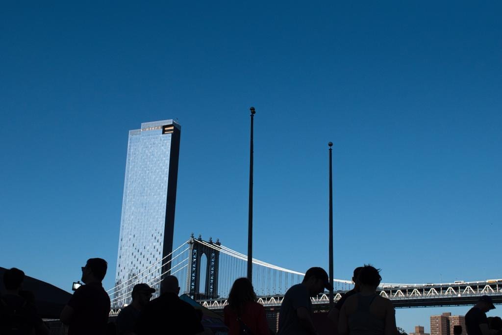 figures in front of Brooklyn bridge