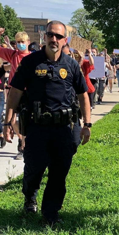 Commander Tuttle marches with Ames protestors.