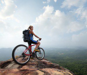 Woman on bike looking at mountains