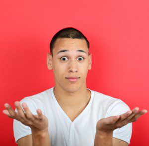 Portrait of clueless man against red background