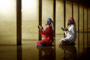 Two Muslim men praying