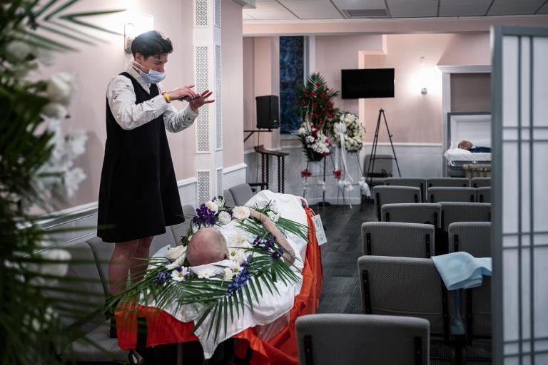 A funeral director calls relatives of a COVID-19 victim for a virtual viewing before cremation on May 22, 2020 in New York City. 