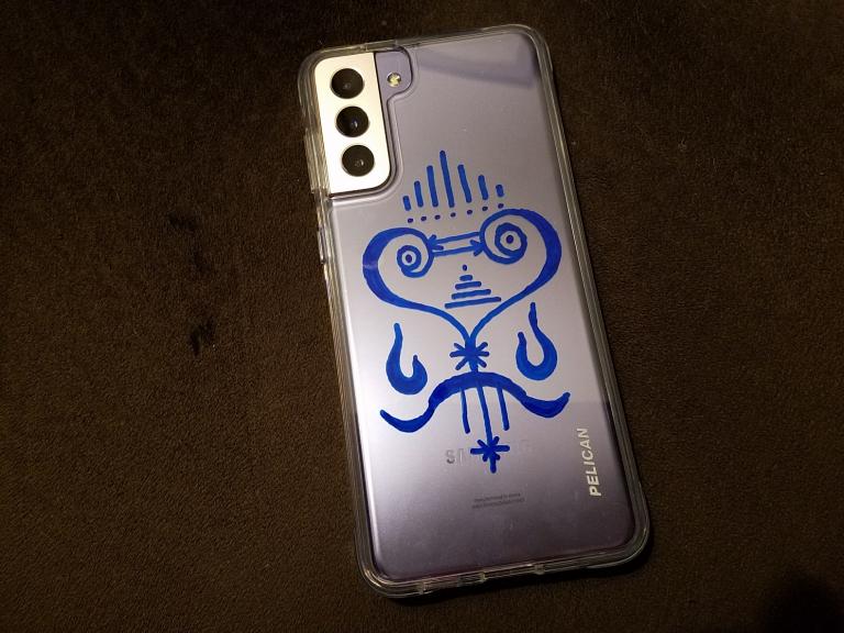 The sigil is drawn on the inside of the phone case using a paint pen. Image by Sidney Eileen