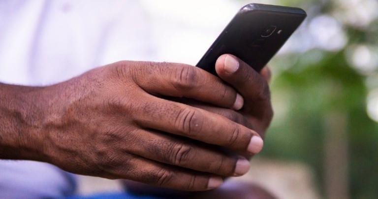 Hands holding a smartphone.