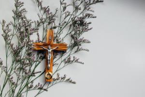wooden crucifix on top of flowers