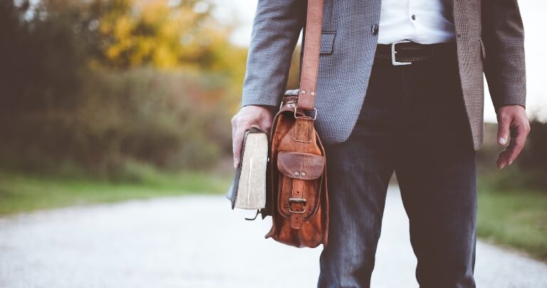 Pastor with a bag and a book.