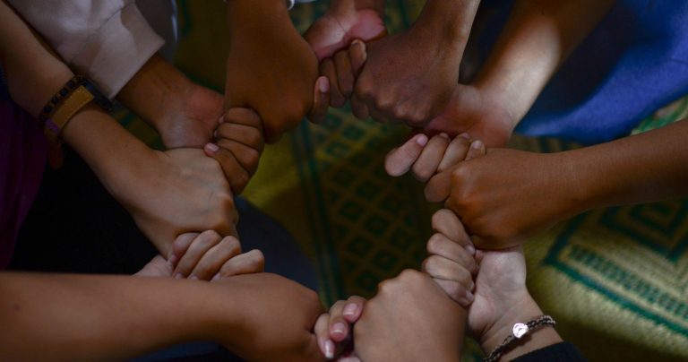 People holding hands in a circle