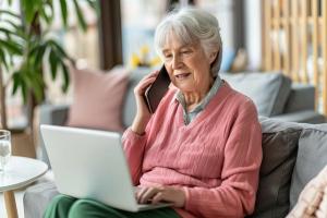 Senior Citizen at laptop and on phone
