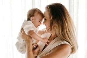 Happy mother holding infant