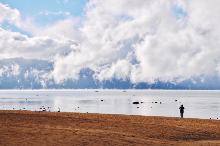 Person walking engaging in their inner work at the ocean