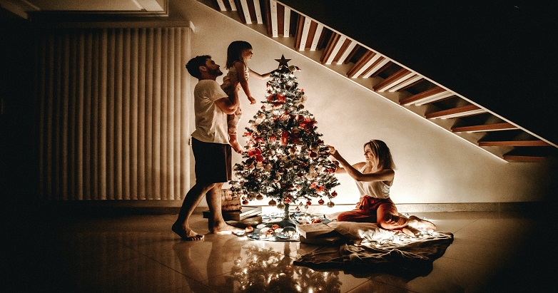 family decorating Christmas tree