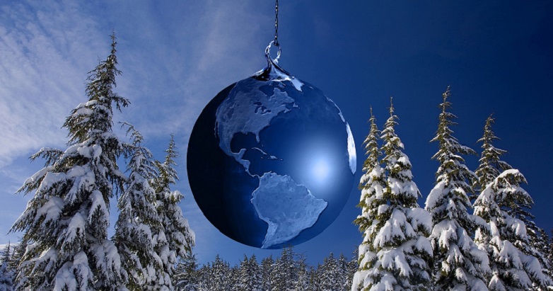 Snowy Christmas trees with blue globe ornament in between