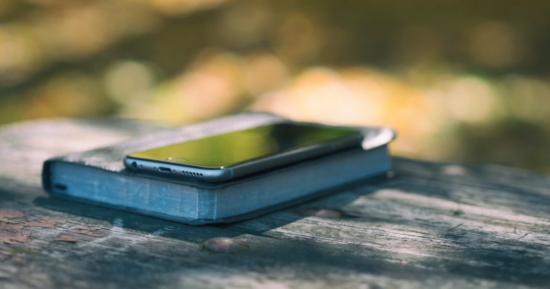 Which is Better—A Paper Bible or Digital? Photo of a cell phone sitting on top of a Bible