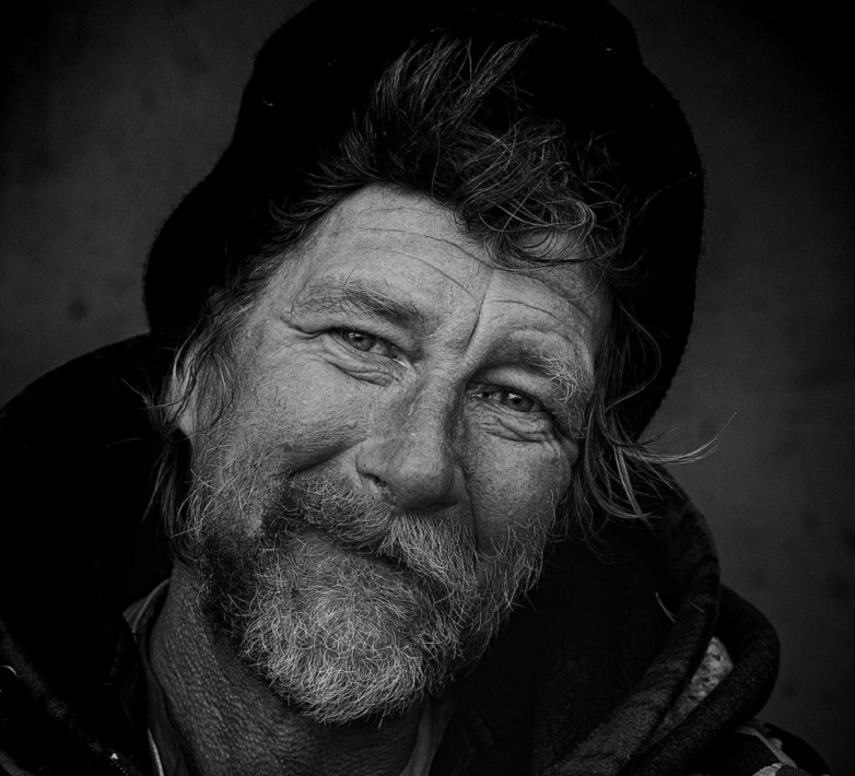 How to be a Giveasheetmotherfather. Black and white photo of bearded homeless man smiling