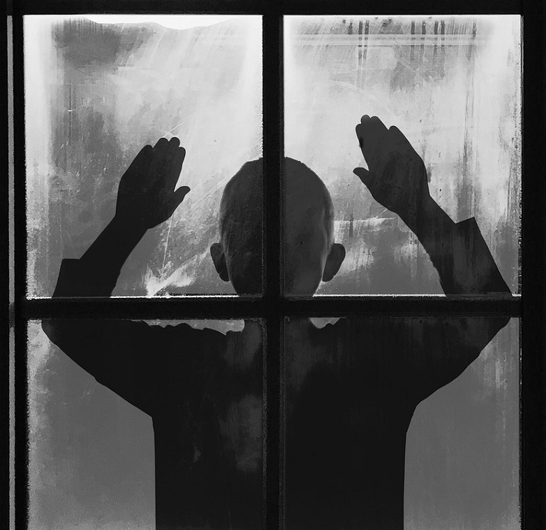 What is the Opposite of Love? Silhouette of a child at a window with arms raised