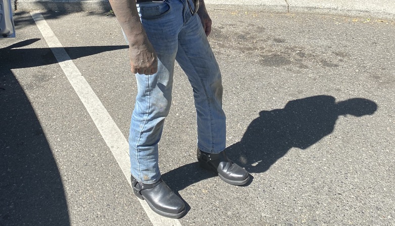 Photo of man's legs in jeans with black boots