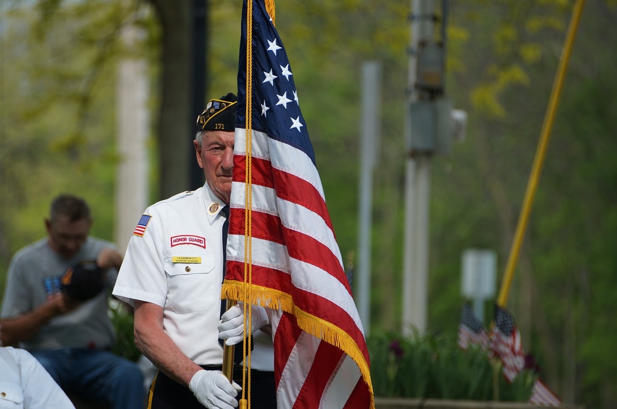 Veteran bearing American flag