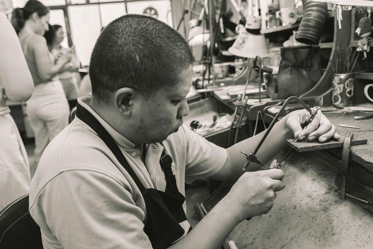 Photo of a young man using a coping saw