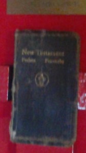 A copy of the New Testament used by Lieut. Funchess and Fr. Kapaun in the POW camp. Funchess explained that it had been taken from him several times; but each time, he was able to steal it back from his captors.