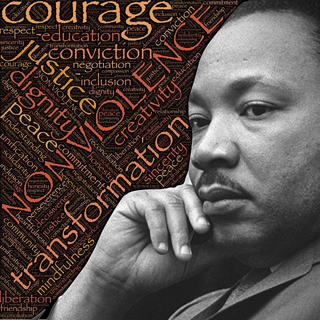 A photo of Dr. Martin Luther King, Jr., against a background of words such as "non-violent" and "courage"