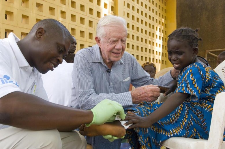 Former U.S. President Jimmy Carter tries to comfort six-year-old Ruhama Issah at Savelugu Hospita