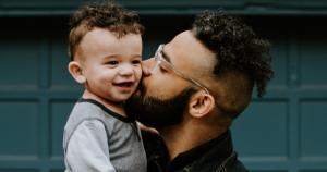 father kisses adopted son