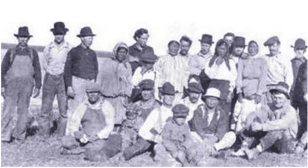 My great grandmother is the small girl standing in front of her mother (third from right). My father's great-grandfather, "Glass Eye Billy," is seated second from left with an unidentified child on his lap. My father's great-great-grandmother is standing in the center in a striped shirt. The photo was taken circa 1924 near the mouth of the Igushik River on Bristol Bay.  (Info from McClatchydc.com)