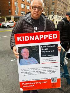 Man Holding Poster of KIdnapped Israeli