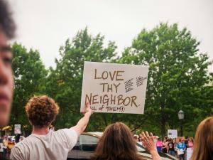 Man Holding Sign at Protest