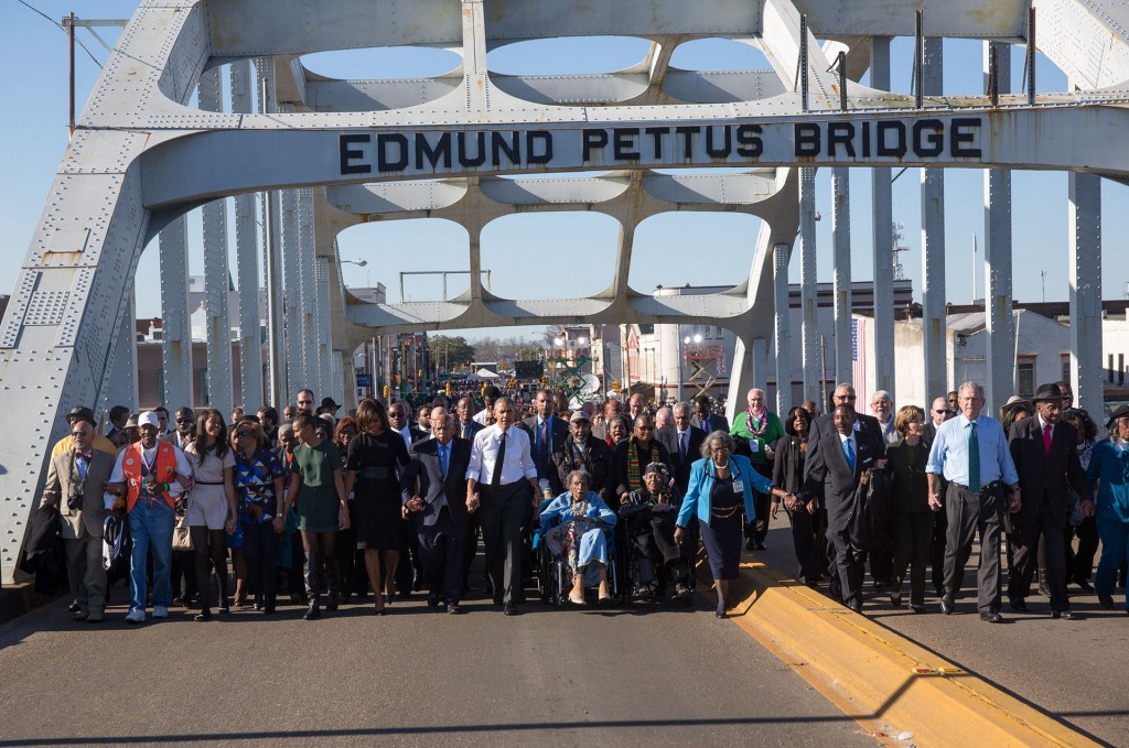 President Obama, former President George W. Bush, and Civil Rights Movement veterans and other commemoration attendees marching across the Edmund Pettus Bridge in March, 2015