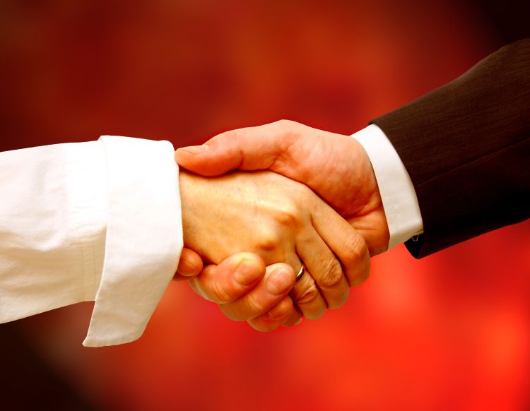 Two hands clasped in covenant agreement representing loyalty to God and obedience as foundation of provision