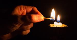 Match lighting a candle.