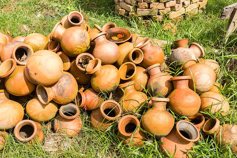 a mound of clay pots in the grass
