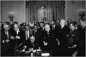 President Lyndon Johnson signing the Civil Rights Act of 1964 into law on July 2, 1964.