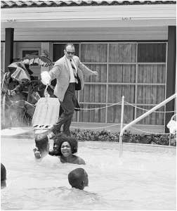 James Brock, Manager of Monson Motor Lodge, St. Augustine, FL pouring muriatic acid into motel pool with desegregated group of swimmers in 1964