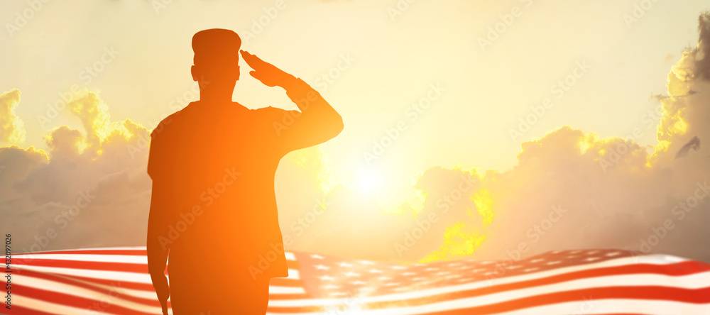 Soldier saluting the flag in the sun