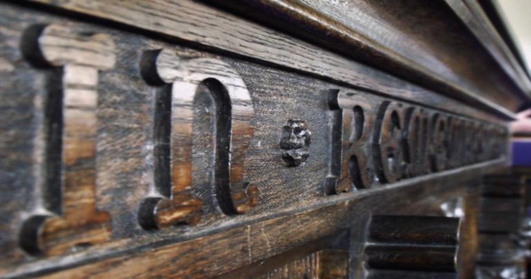 Close up picture of "In Remembrance" on a communion table