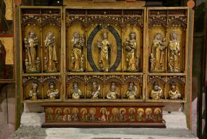 A Triptych with saints like Mary, Susanna, and Anne. Christ is at the center.