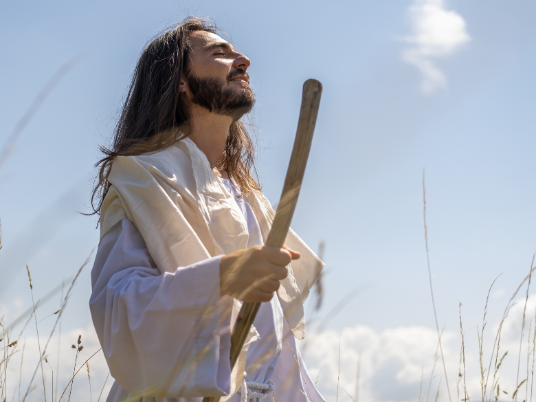 Jesus smiling in a field