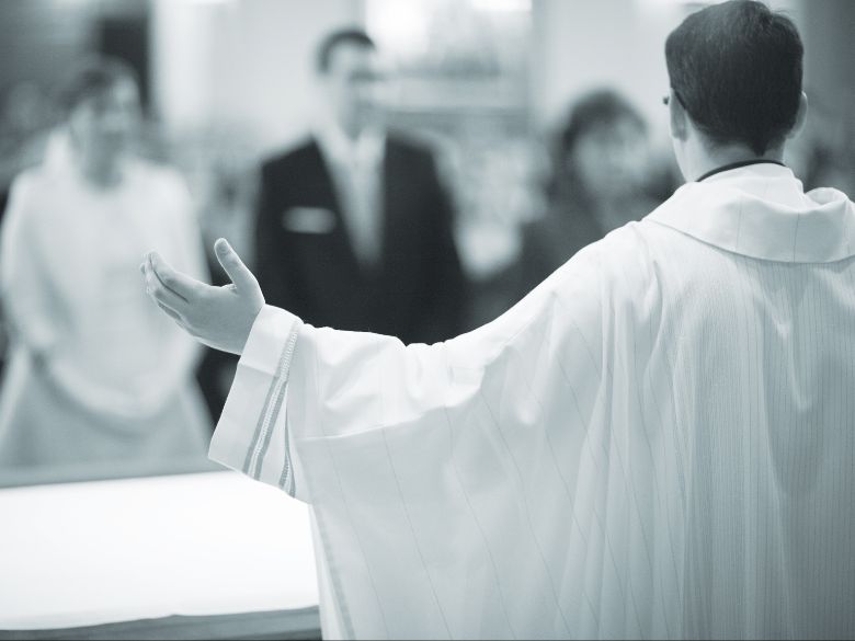 priest marrying two Catholics in a wedding ceremony