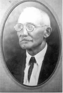 Black and white image of an older gentleman with glasses
