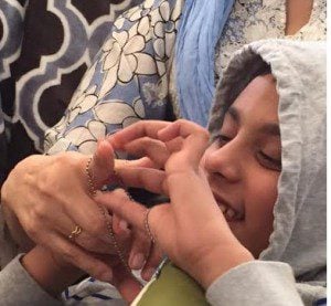 D happily  twirling beads around his Nanijan's (grandmother)'s finger