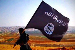 A militant with the black flag of ISIS. Image obtained through Creative Commons. 