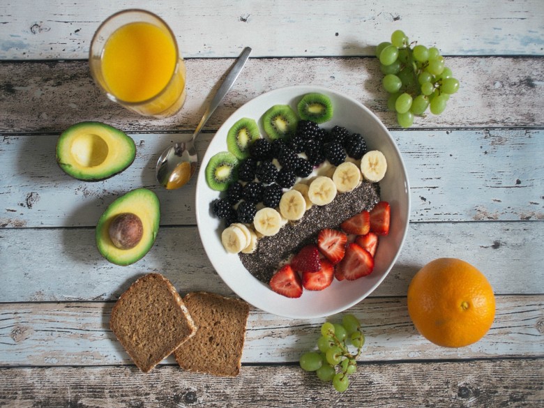 Fruit smoothie bowl with bananas, strawberries, blackberries, kiwi, and chia seeds.