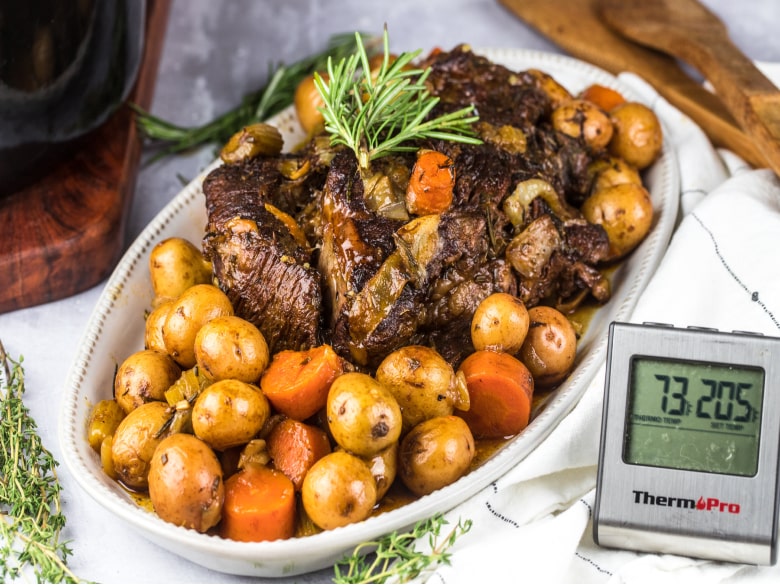 Slow cooker recipe for pot roast with potatoes and carrots on a serving plate.